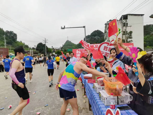 鎮(zhèn)寧鄉(xiāng)親在沿途為跑者送上甜蜜蜂糖李。