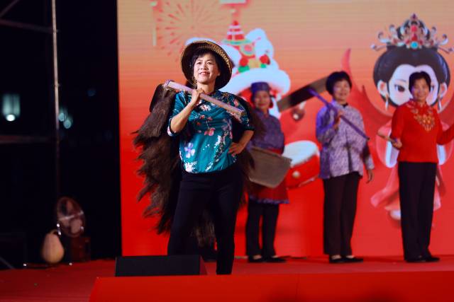 河源凤安，村民们穿戴着传统服饰，手持传统农具，在舞台上迈出自信步伐，弘扬农耕精神。